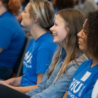Thompson Scholars sitting in the audience with all smiles on their faces.